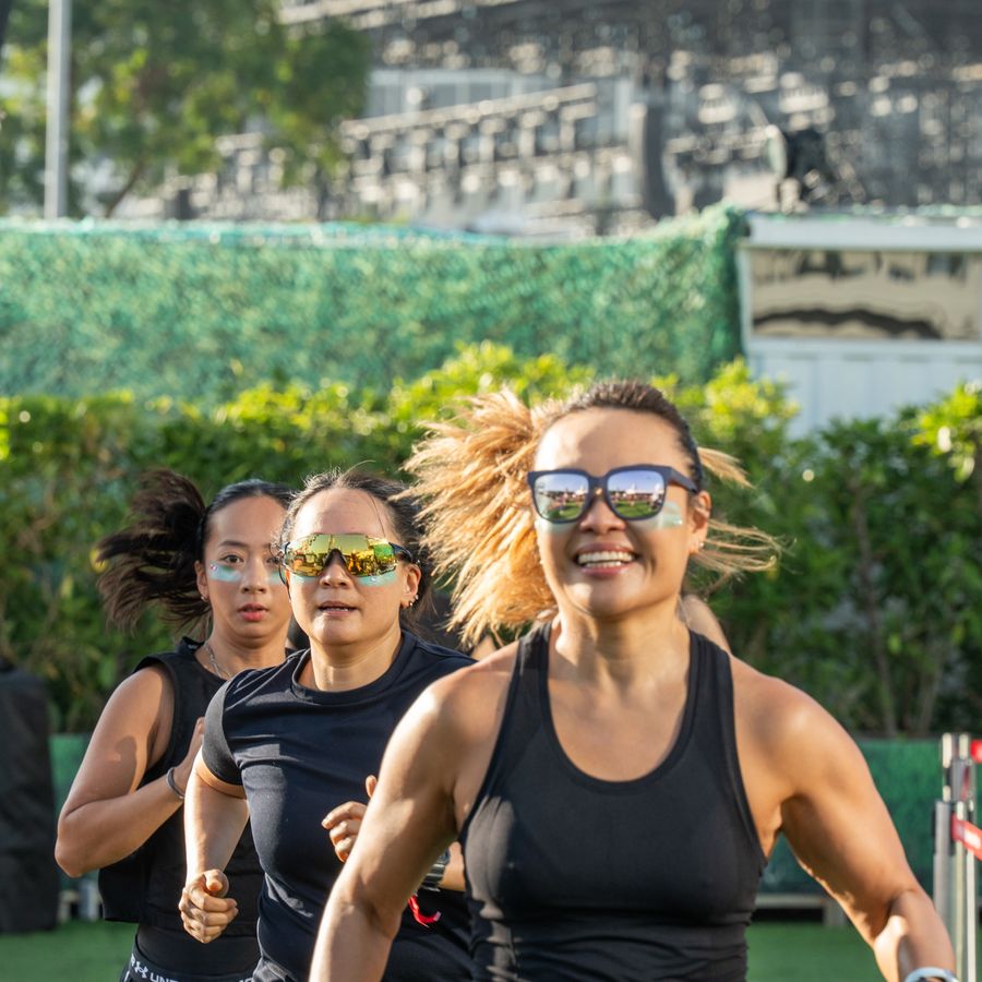 Three athletes running the loop together