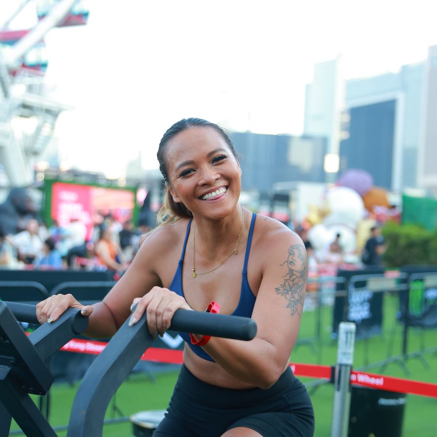 An athlete on the echo bike with the city behind