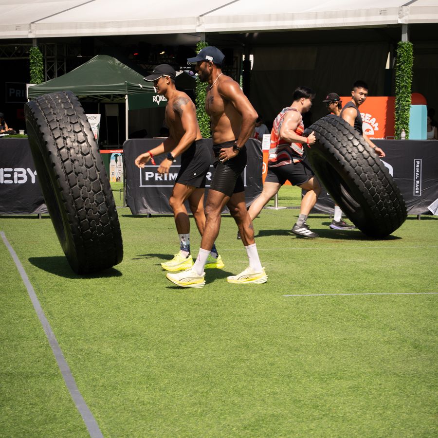 Athletes flipping tyres side by side