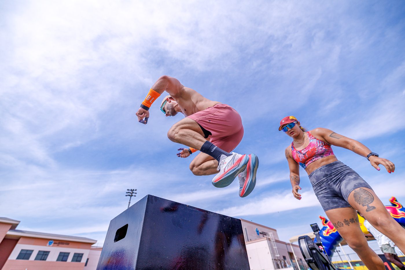 Two athletes on the burpee box jump over at a Primal race