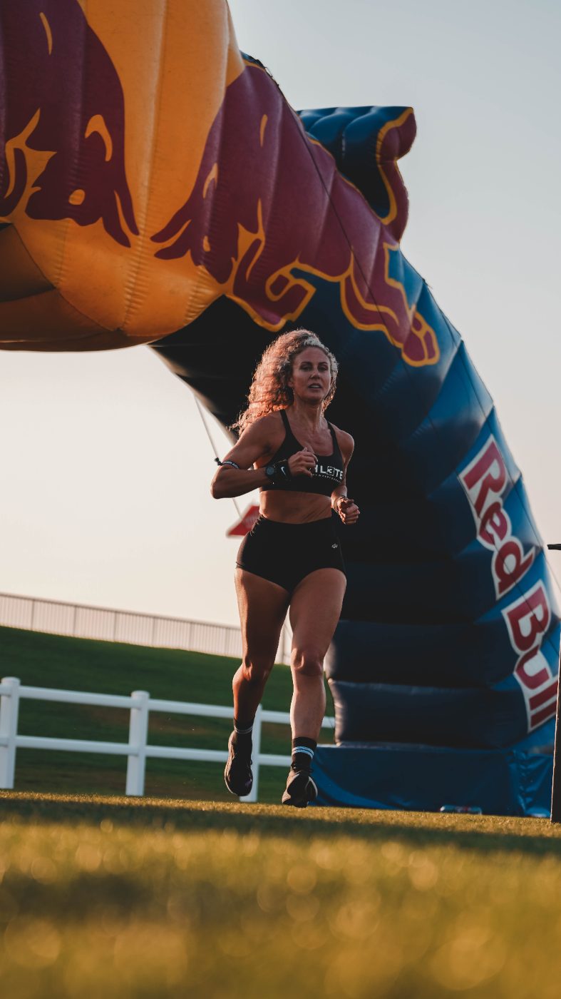 An athlete running out of the arch at a Primal race
